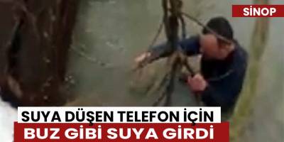 Suya düşen telefon için buz gibi suya girdi