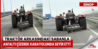 Traktör arkasındaki sabanla asfaltı çizerek karayolunda seyir etti