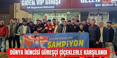 Dünya ikincisi güreşçi çiçeklerle karşılandı